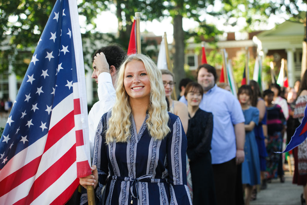 students line up with flags during the procession at convocation