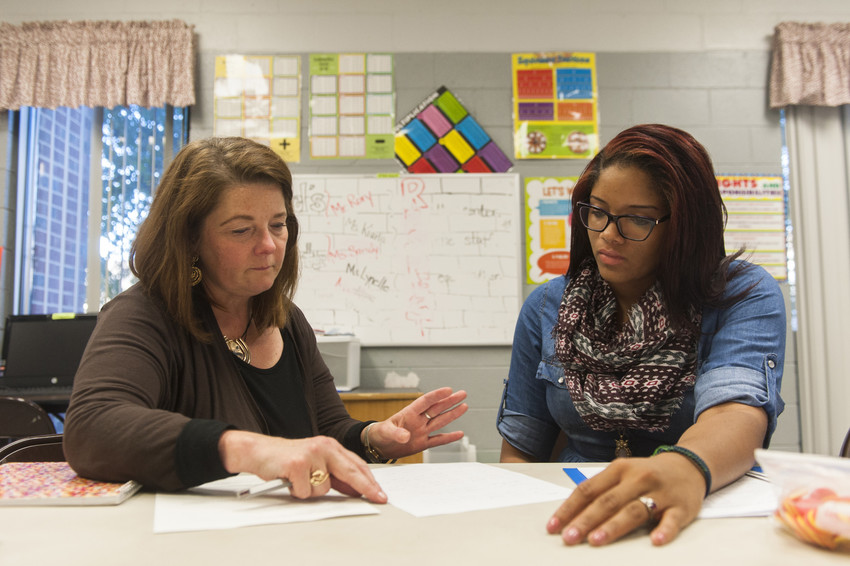 a professor coaches a student on teaching techniques