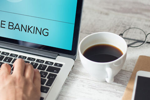 A close-up of a person's hands typing on a keyboard