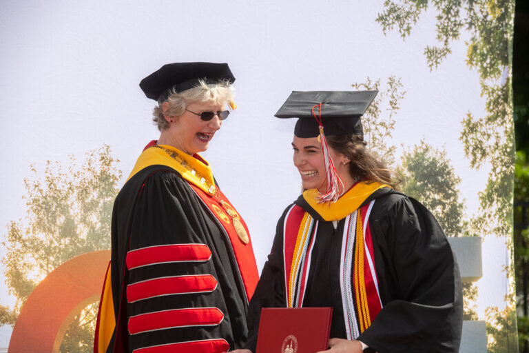 President Dr. Alison Morrison-Shetlar congratulates a member of the Class of 2022.