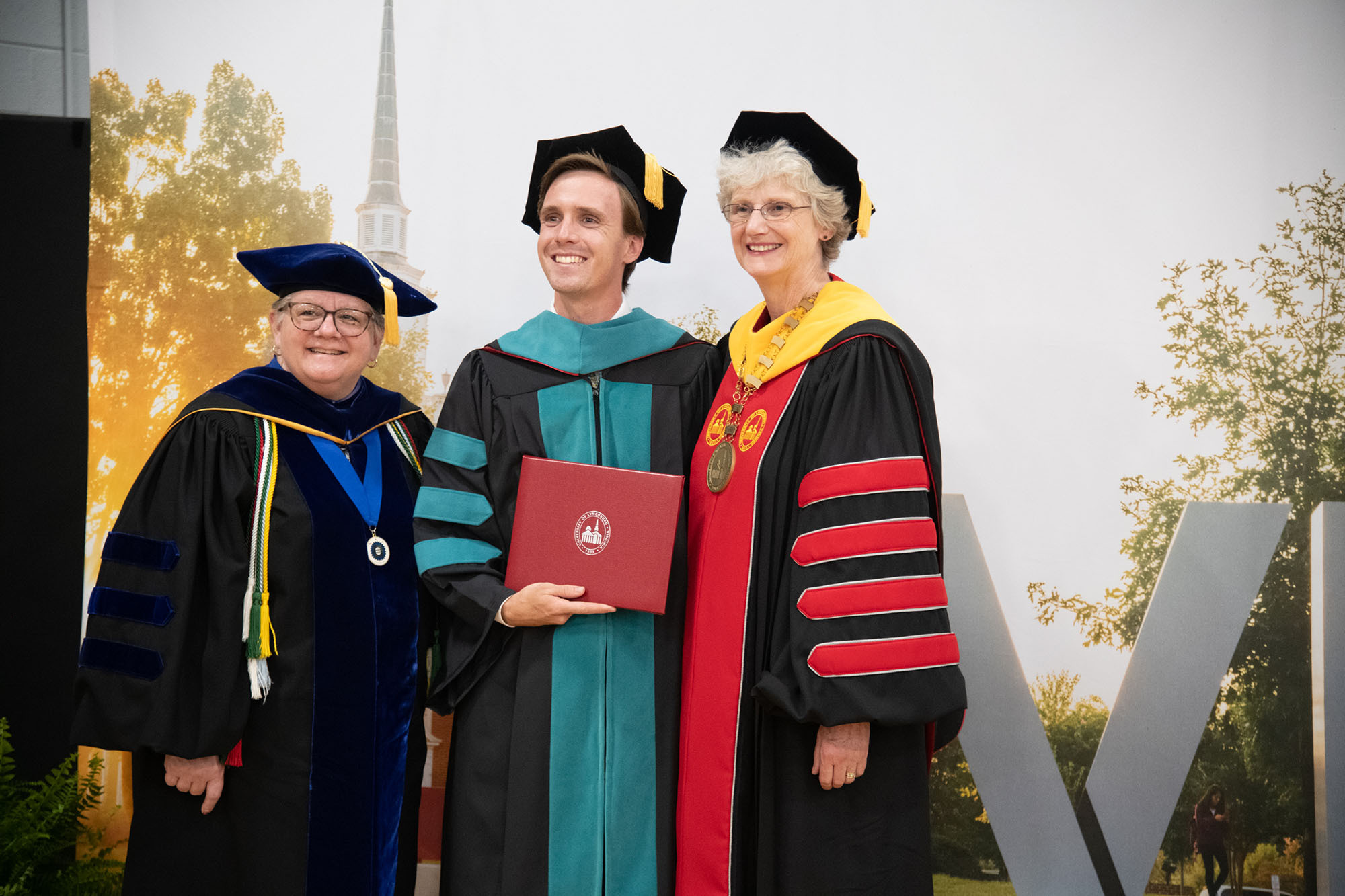 DPT ceremony President Alison and Provost Allison with a graduate