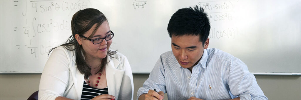 A tutor helping a student with a math problem