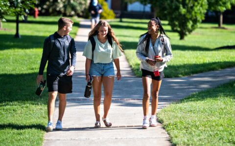 Students walking on the Dell on the first day of class