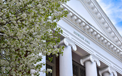 Building with white columns and blossoming tree