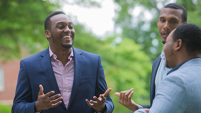 A Master of Business Administration (MBA) student talks with other students.