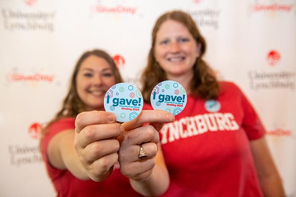 Two UL staffers holding "I Gave" buttons.