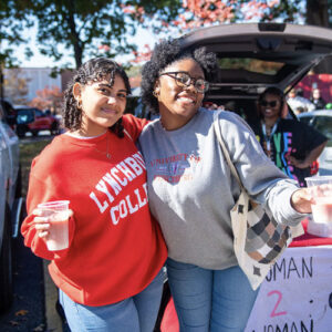 Two people smiling for the camera at homecoming.