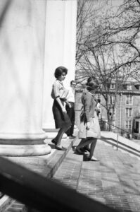 Students walk down the steps of Hopwood Hall.