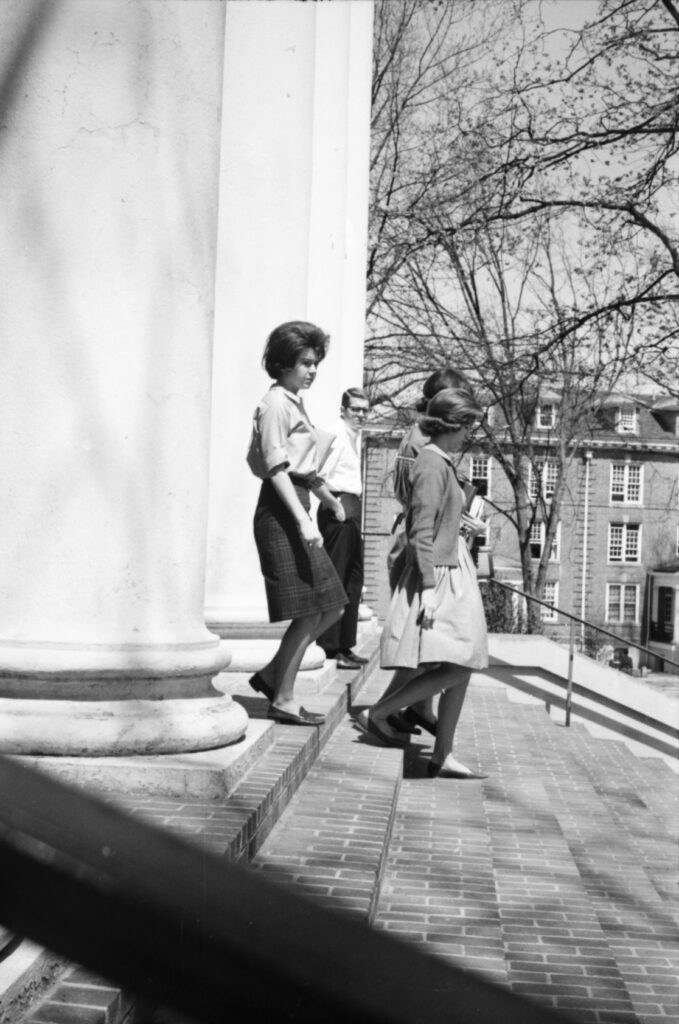 Students walk down the steps of Hopwood Hall.