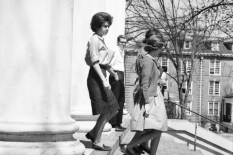 Students walk down the steps of Hopwood Hall.