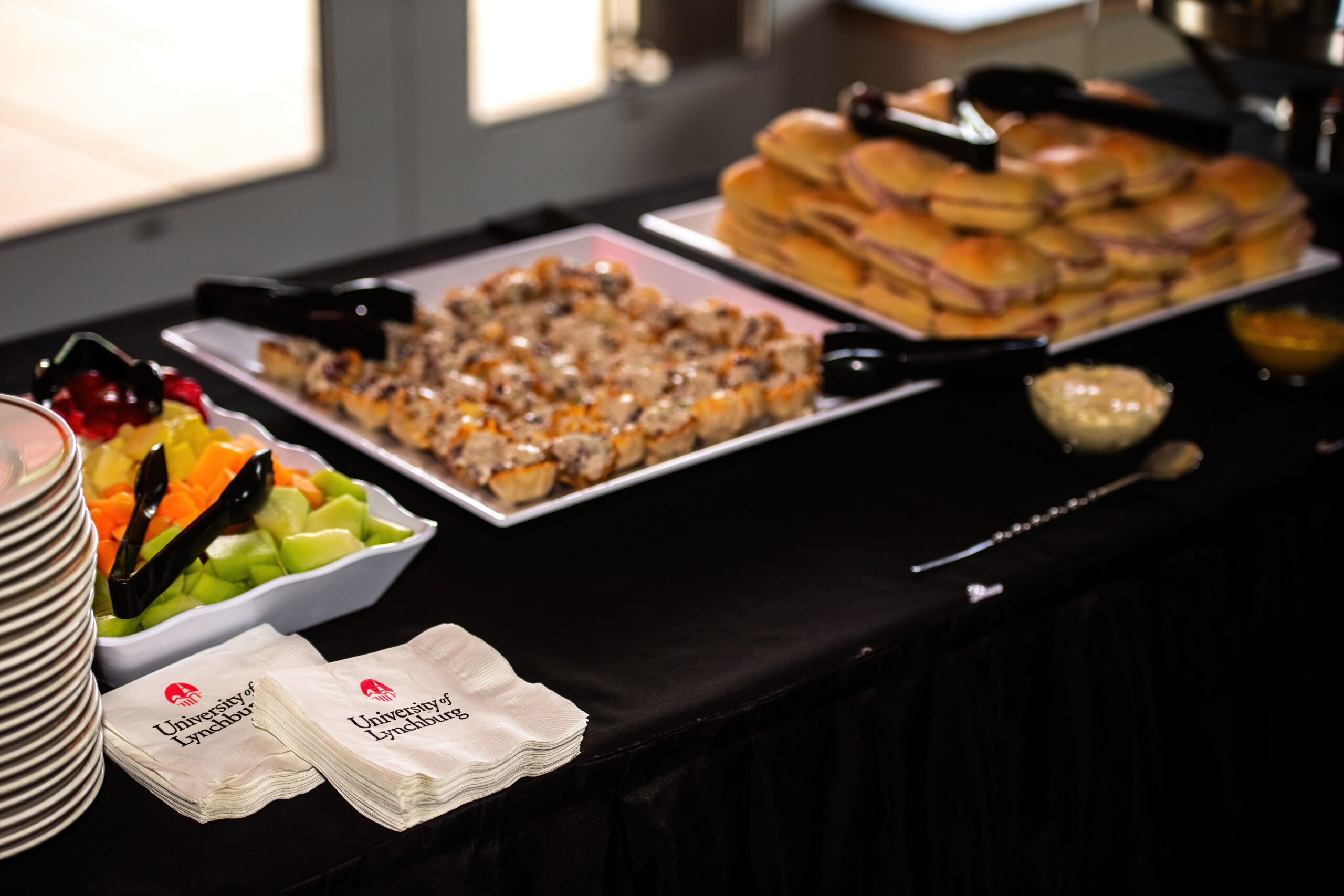 Buffet trays of sliders, carrot sticks and napkins