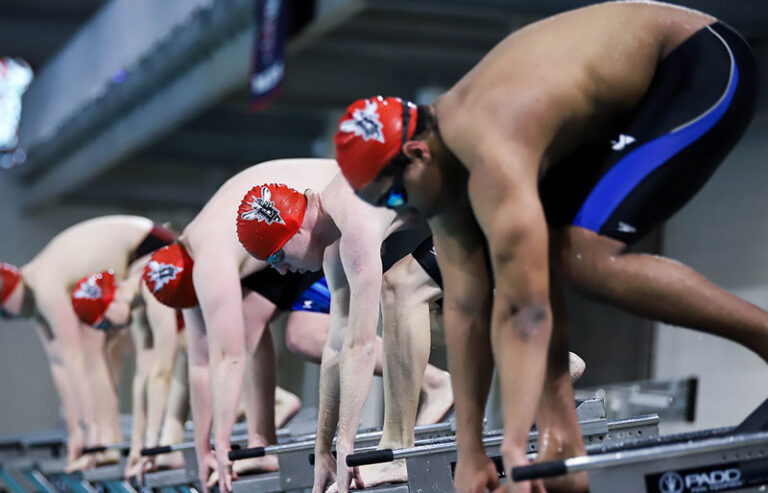Swimmers lined up about to dive