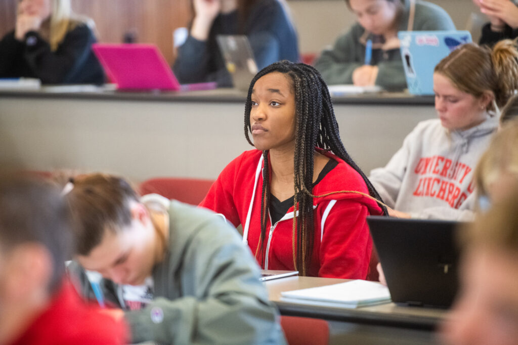 Students listen to instruction in a classroom.