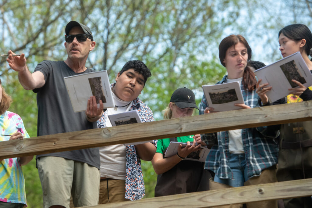 A professor teaches his students outside.