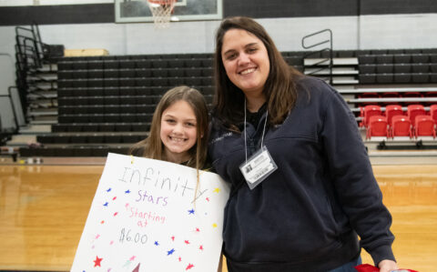 A teacher poses for a photo with her student