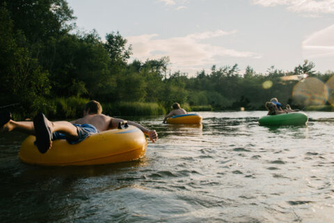 People tubing down a river.