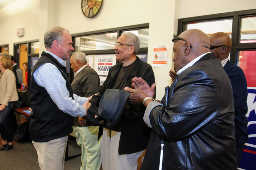 Dr. Owen Cardwell (center) shakes hands with Sen. Tim Kaine (left), when Kaine visited the University in 2018.