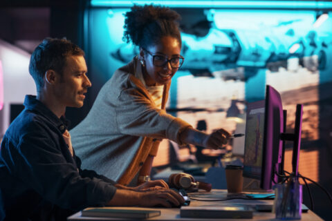 Photo of two people at a computer