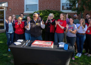 Group photo with cake on GiveDay