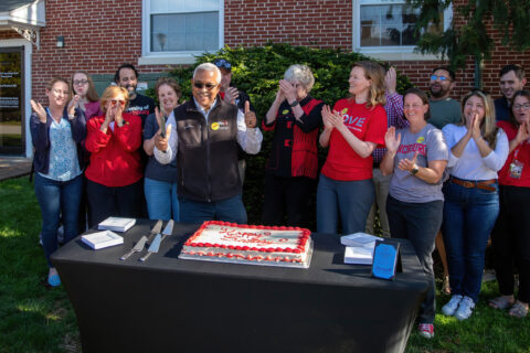 Group photo with cake on GiveDay