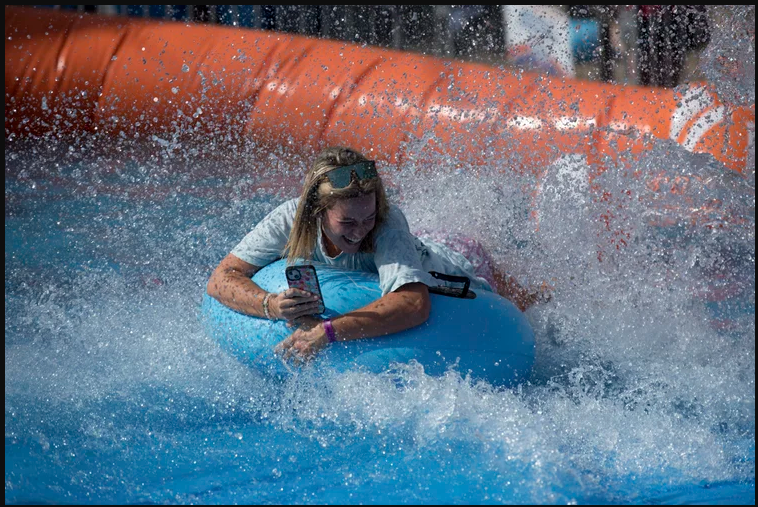 A girl goes down a water slide