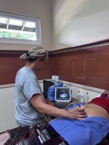 Bryn Kroto performs an ultrasound on a pregnant woman. 