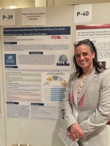 Bryn Kroto stands with her poster at the World Association for Disaster and Emergency Medicine's Congress on Disaster and Emergency Medicine. 