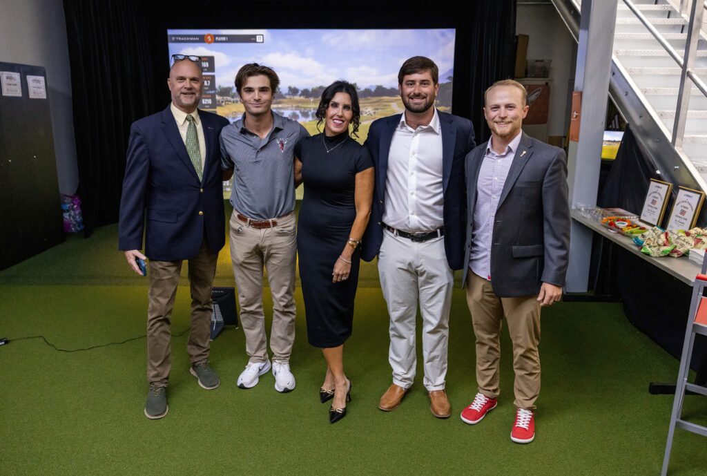 Group at dedication of golf simulator.