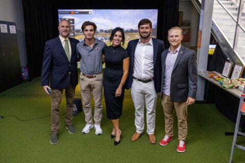 Group at dedication of golf simulator.