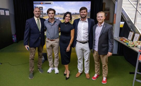 Group at dedication of golf simulator.
