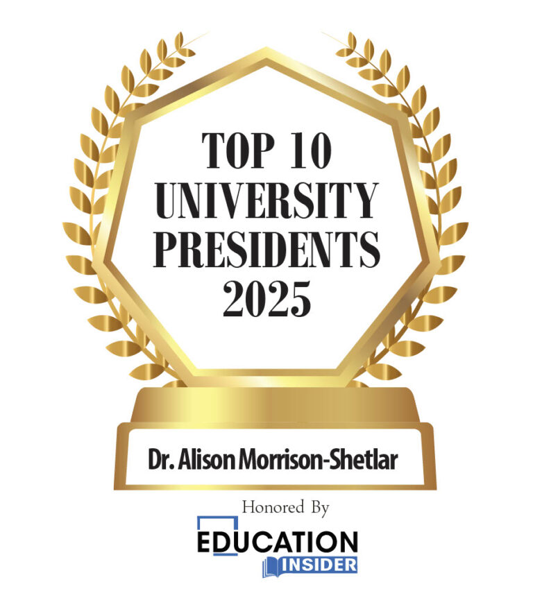 A graphic of a golden award lined with laurel leaves. The inside says "Top 10 University Presidents of 2025." The award is dedicated to Dr. Alison Morrison-Shetlar.