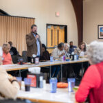 A group of citizens and University officials speak at the Community Mountain.