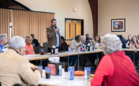 A group of citizens and University officials speak at the Community Mountain.