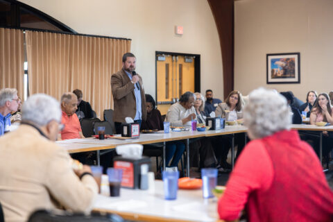 A group of citizens and University officials speak at the Community Mountain.