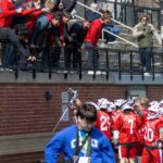 Alums in the stands celebrate with the men’s lacrosse team at the 2026 Mustang Classic in March. Photo by Bill Gerke.