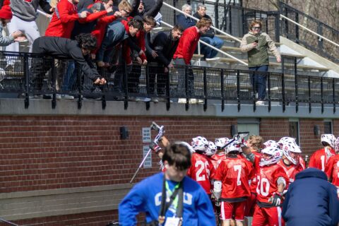 Alums in the stands celebrate with the men’s lacrosse team at the 2026 Mustang Classic in March. Photo by Bill Gerke.
