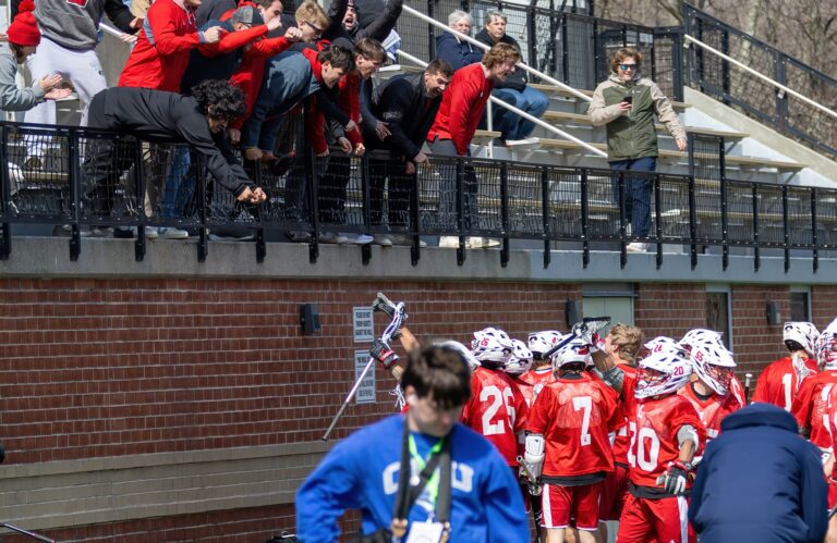 Alums in the stands celebrate with the men’s lacrosse team at the 2026 Mustang Classic in March. Photo by Bill Gerke.