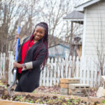 Dr. Ghislaine Lewis works in a garden.