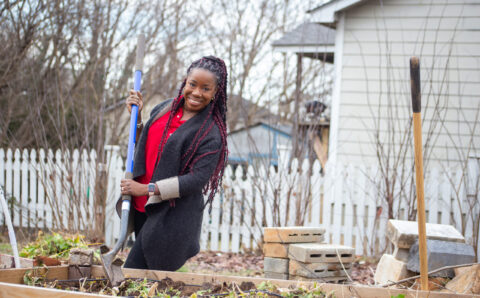 Dr. Ghislaine Lewis works in a garden.