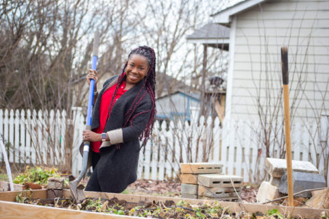Dr. Ghislaine Lewis works in a garden.