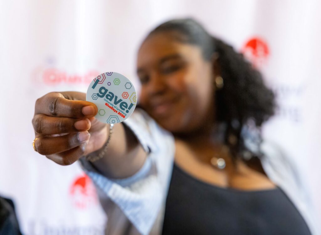 Woman holding an "I gave!" sticker