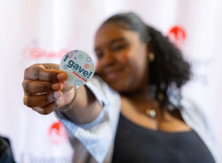 Woman holding an "I gave!" sticker