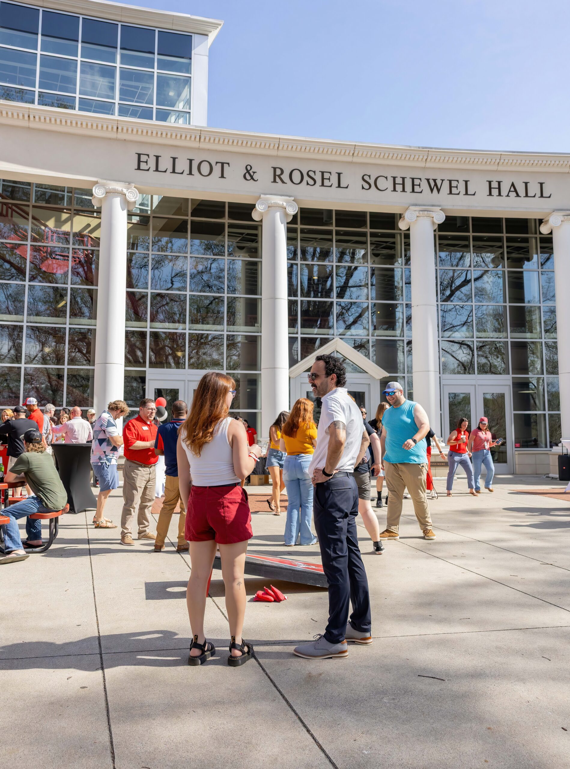 fridays on the dell; crowd of people mingling outside of Schewel Hall