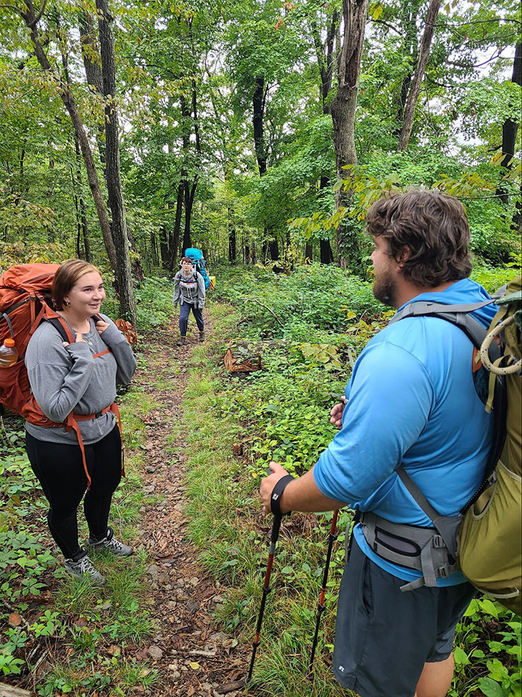 Students backpacking on a trail
