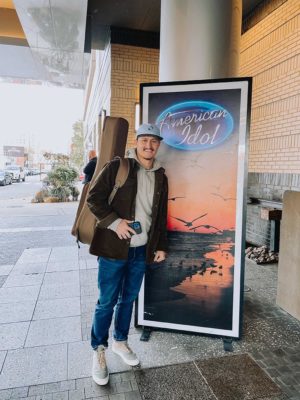 Danny Czerkawski '16 standing in front of American Idol poster