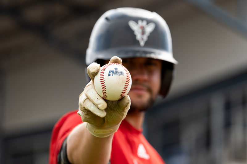 baseball player looking at camera holding baseball