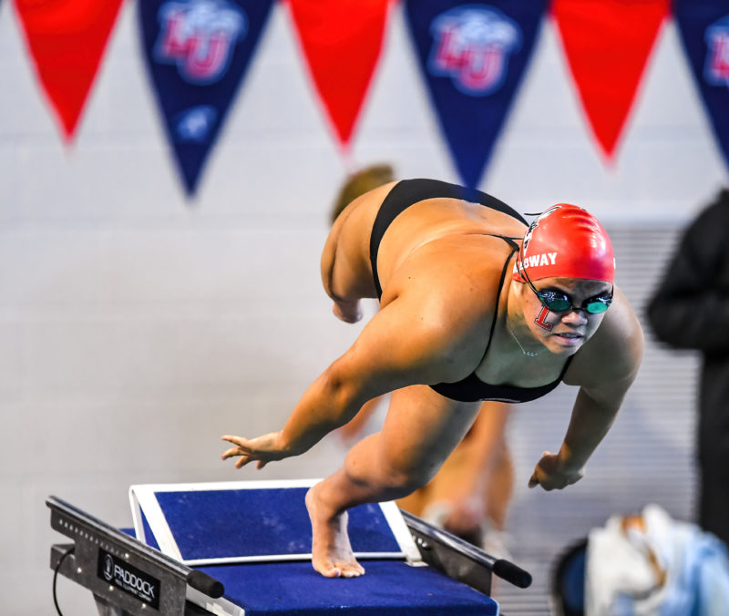 Mei White '26 dives off the block at a recent swim meet. 