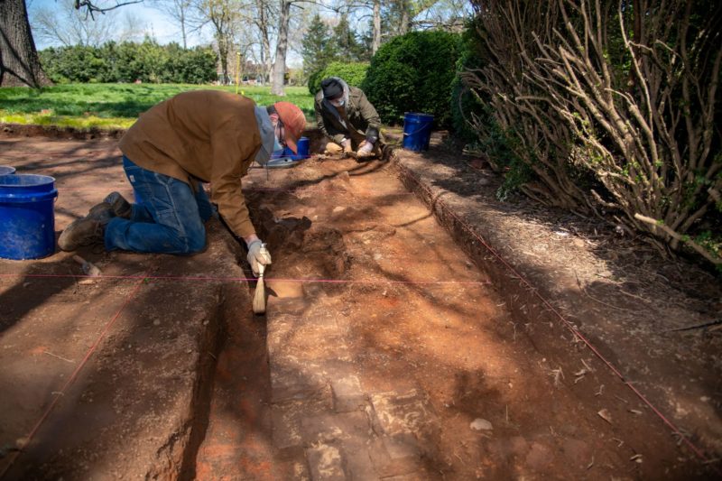 Lynchburg graduate Eric Taylor ’19 (left) and Randy Lichtenberger (right), archaeologist and director of cultural resources for H&P, work at the kitchen house site on April 2, 2021