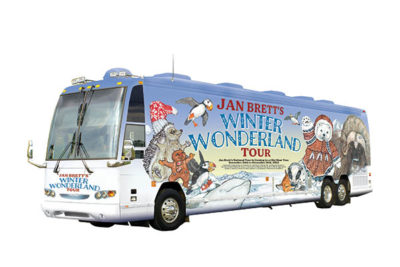 A tour bus decorated with children's book illustrations and the words "Jan Brett's Winter Wonderland Tour"