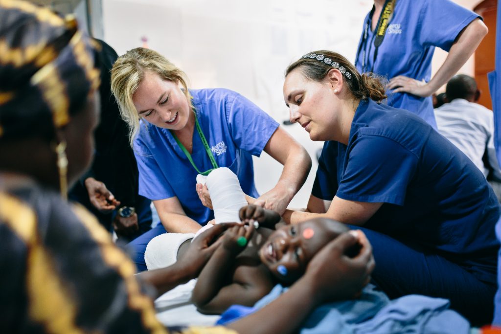 Mary Deis ’16 helps treat a patient on board the Africa Mercy.